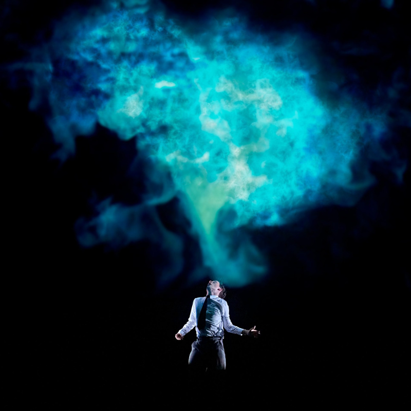 Blue smoke rises from a man convulsing.jpg